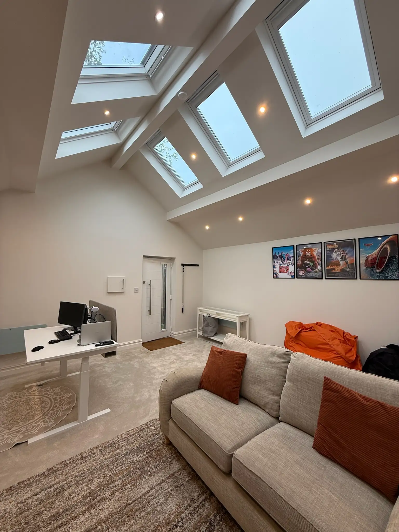 Garage converted into a bright home office with roof lights and a sofa
