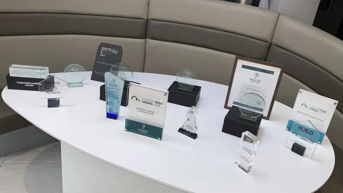 Convert Your Garage industry awards displayed on a table